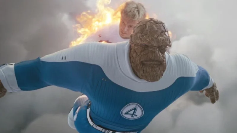 Scene from Fantastic Four First Steps movie showing Human Torch carrying The Thing